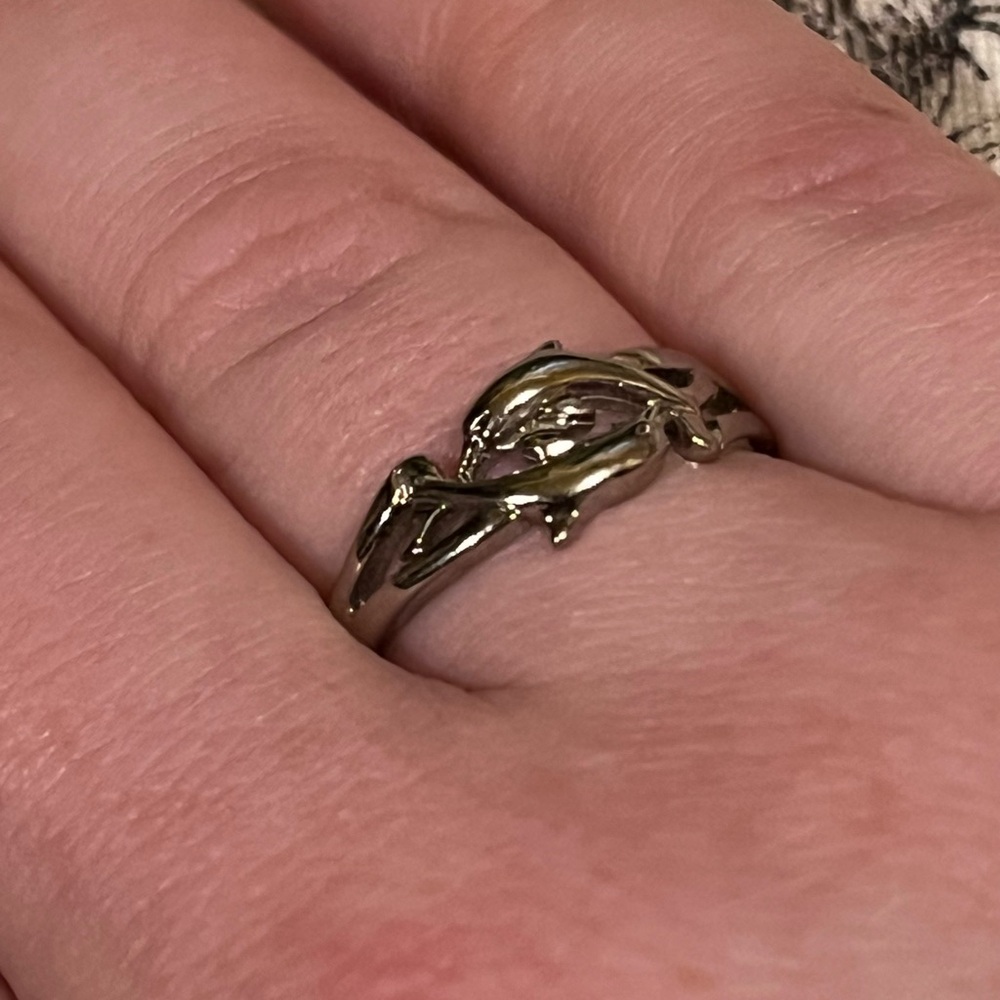 SILVER COLORED DOLPHIN RING.